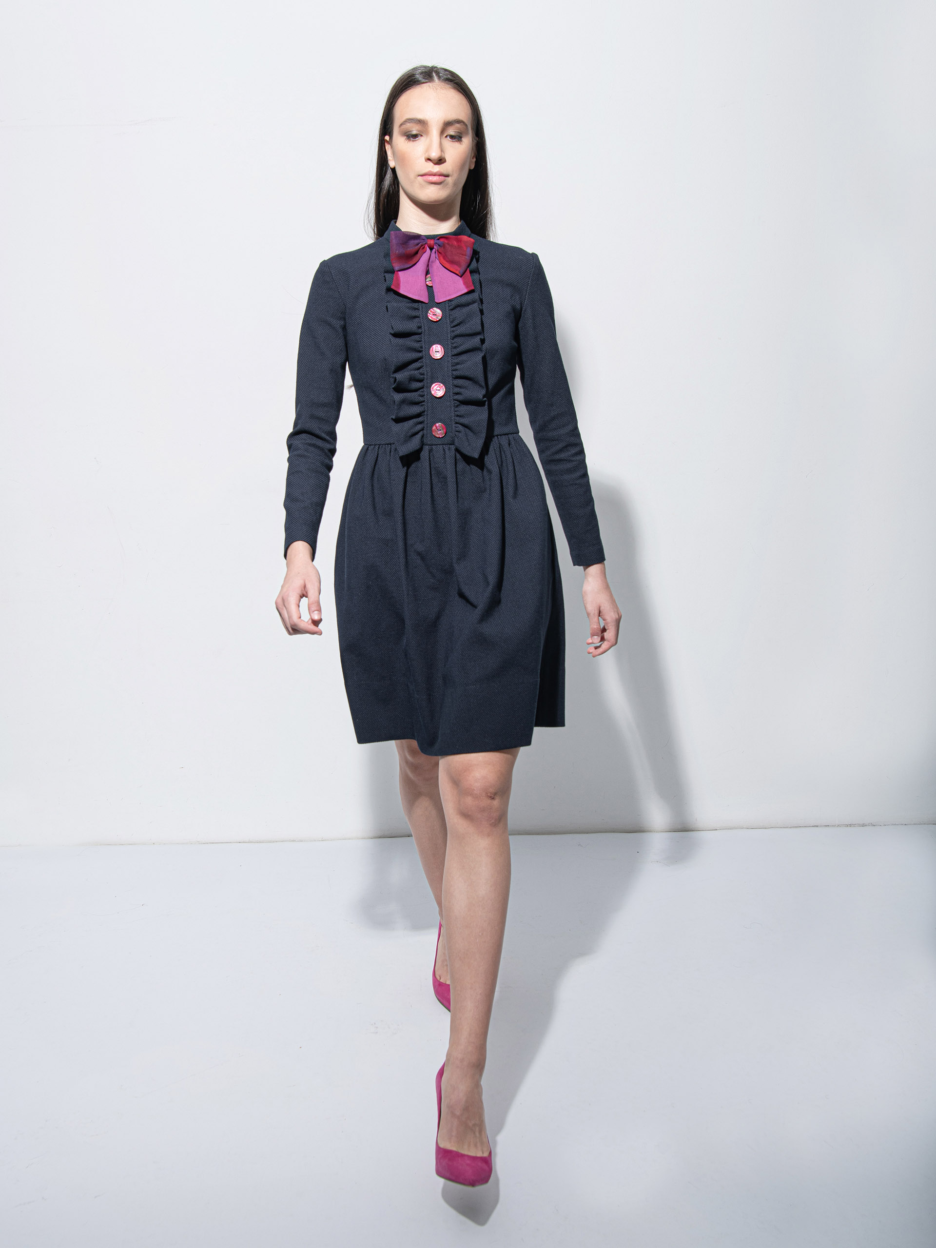 Navy blue dress w ruffles and bow walking • Sassa Björg